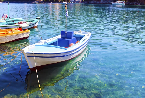Fishing boat reflected on sea — Stock Photo, Image
