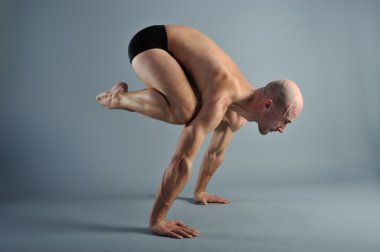 Yoga adam gri arka plan üzerinde poz