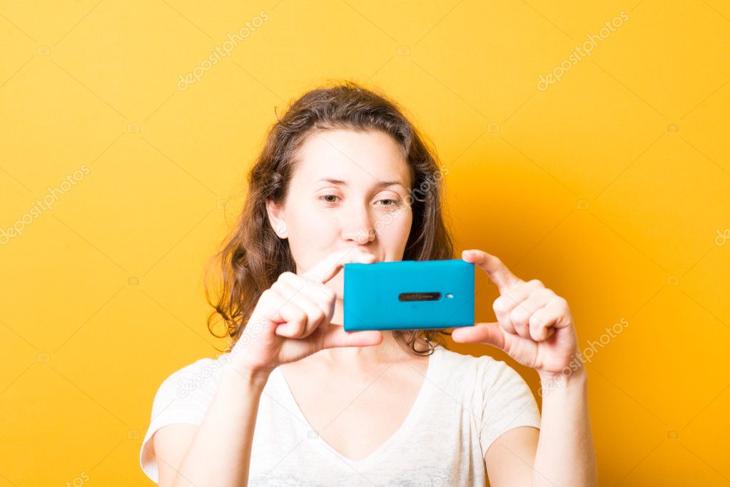 Girl photographing on phone