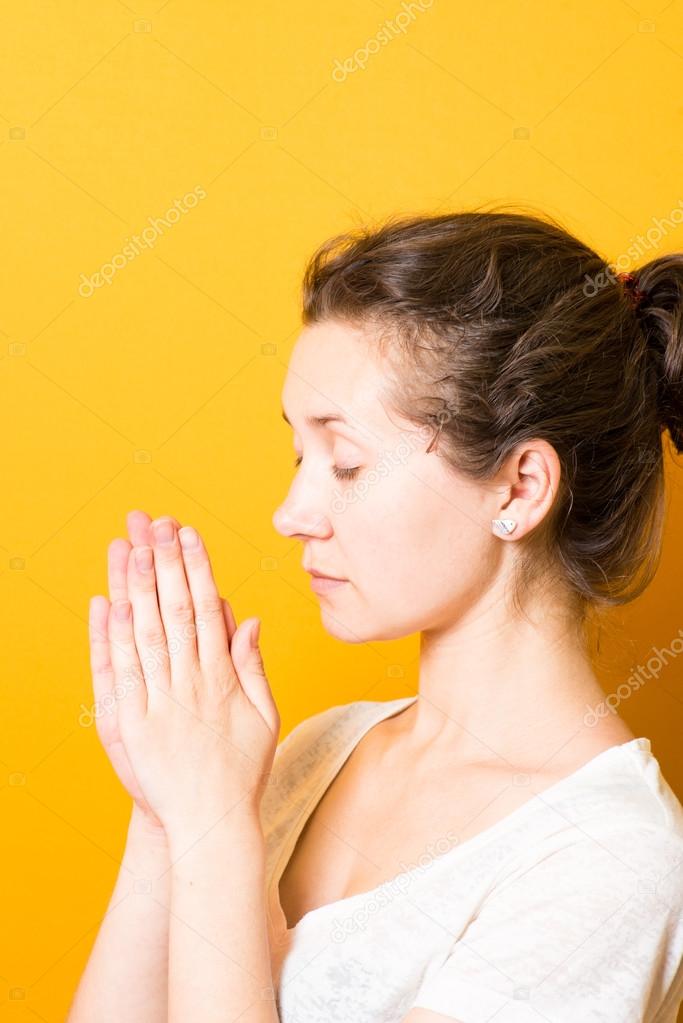 brunette a bright girl prays in harmony