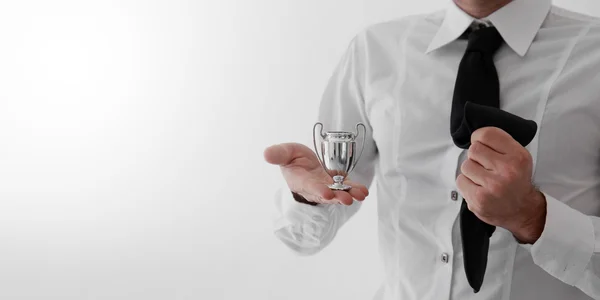 Empresário vencedor segurando um troféu — Fotografia de Stock