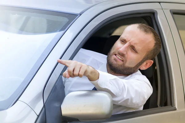 Businessman in his car making a gesture — Stock Photo, Image