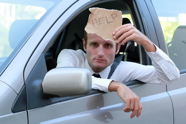 Unhappy driver in his car asking for help — Stock Photo, Image