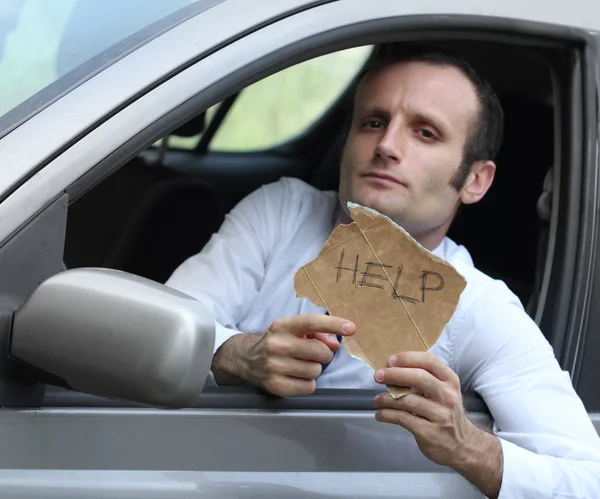 Unhappy driver in his car asking for help — Stock Photo, Image