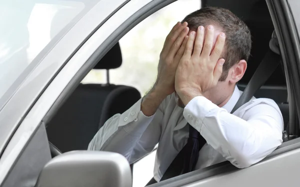 Unhappy driver in his car — Stock Photo, Image