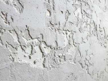 Beyaz desenli duvar kaba alçı yapı malzemesi arkaplanını gösteriyor