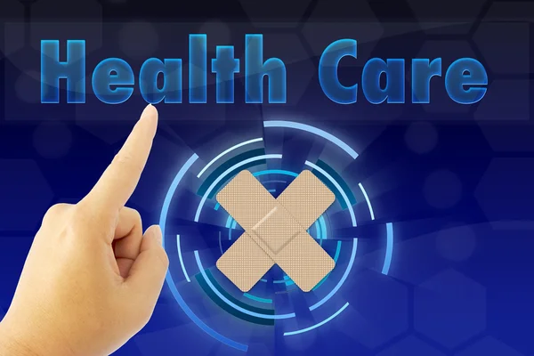 Hand zeigt "Gesundheitswesen" -Wort auf blauem Bildschirm — Stockfoto