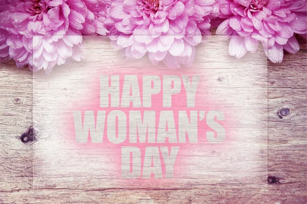 Pink flowers on wooden with word Happy Woman's Day — Stock Photo, Image