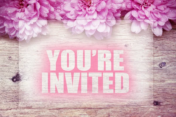 Pink flowers on wooden with word Your're invited — Stock Photo, Image