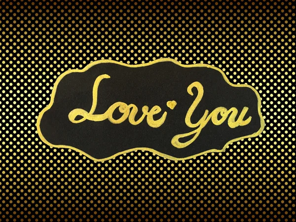 Handwritten word "love you" on golden polka dot background — Stock Photo, Image