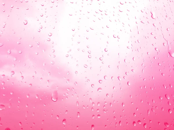 Regndroppar på glas fönster, rosa himmel bakgrund — Stockfoto