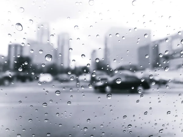 Gotas de chuva na janela do carro na cidade, estilo preto e branco retro — Fotografia de Stock