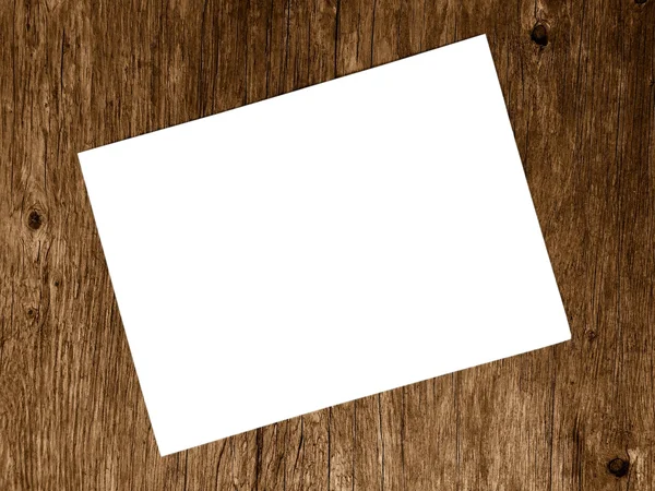 Blank white paper on blurred of wooden background — Stock Photo, Image