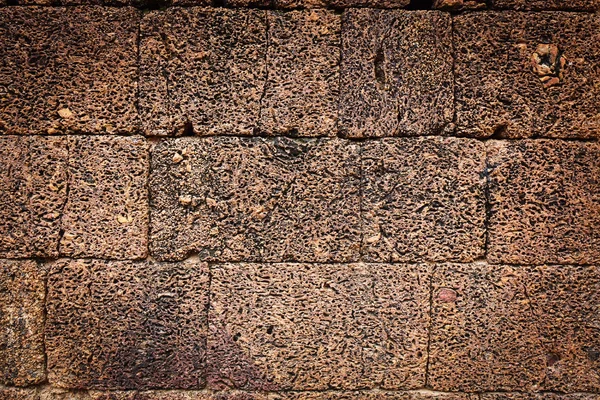 Textura irregular erosionada de una vieja pared de piedra — Foto de Stock