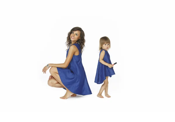 Mother and daughter in same dresses — Stock Photo, Image
