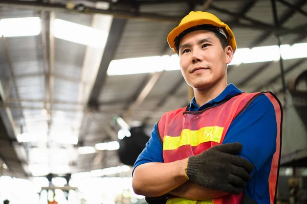 Portrait of industrial worker standing with tablet holding in her hand feeling proud and confident looking for the new opportunity, new challenge, concept manufacturing industry, Professional worker.