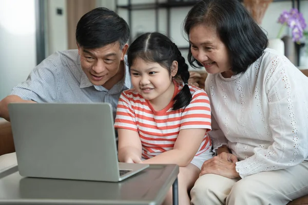 Grandparents and granddaughter have family meeting through VIDEO call, online, internet technology, new normal, playing game,