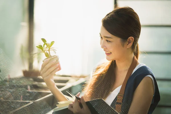 Medium Close Shot Young Asian Woman Holding Notebook Looking Little — Fotografia de Stock