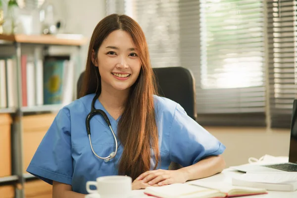 Odada Otururken Kameraya Gülümseyen Asya Kadın Doktor Veya Hemşire Portresi — Stok fotoğraf