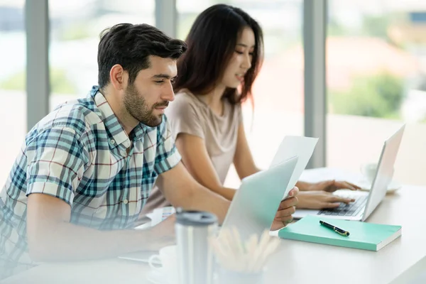stock image Young couple man and woman student in casual lifestyle concentrate working together with laptop in brightness atmostphear, and looking at laptop, Life style of young generation in university.