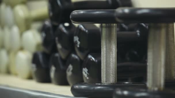 Dumbbells in the gym for the background — Stock Video