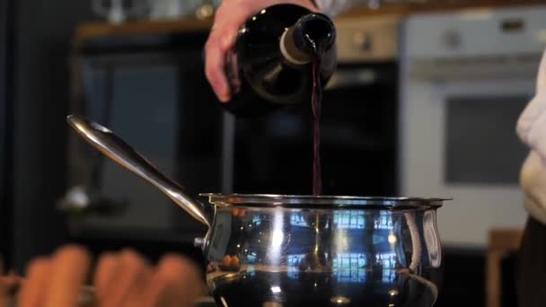 Gros plan homme versant du vin rouge dans une casserole Séquence Vidéo Libre De Droits