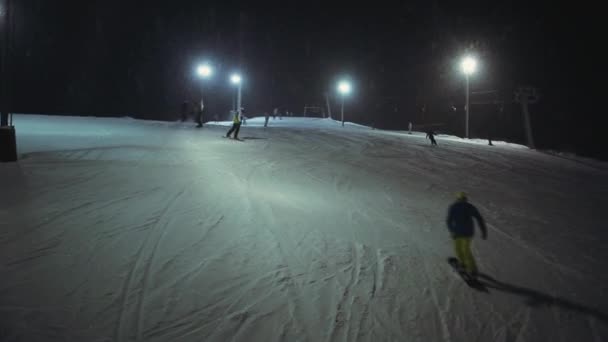 Aerial shot snowboarders ride the ski resort — Stock Video