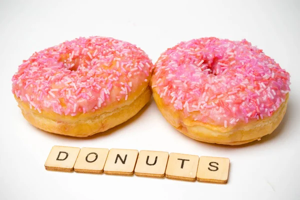 Twee Iced Ring Donuts Een Witte Achtergrond Met Een Gebarentaal — Stockfoto