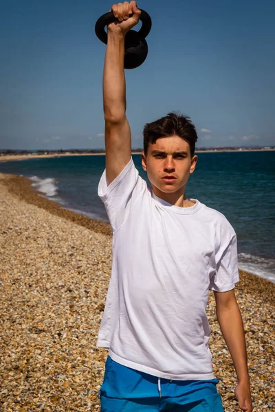 Årig Kaukasisk Tonårspojke Strand Som Tränar Med Kettlebell Vikt — Stockfoto