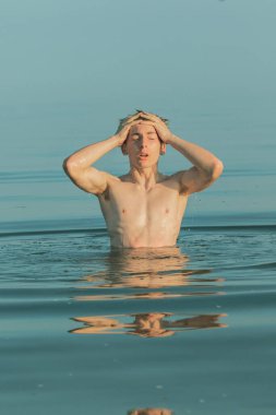 Teenage boy sufacing in the sea on a warm summer's day
