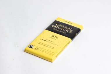 Londra, Birleşik Krallık, 22 Ekim 2025 - Beyaz arka planda yeşil ve siyah organik beyaz% 30 kakao çikolatası manzarası