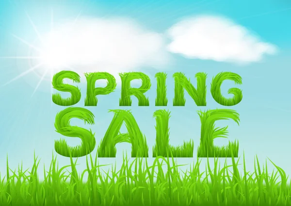 Spring sale inscription made of grass. Spring background with green early spring grass on blurred soft background.