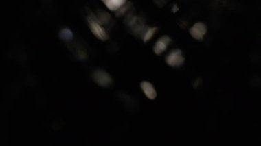 Karanlıkta 4k Soyut Kristal Bokeh. Düzenleme için arkaplanı üst üste koy. Parlak Işık Sızıntısı