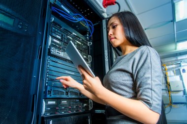 Engineer businesswoman in network server room clipart