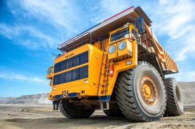Siberia, Russia - July 20, 2015: Big yellow mining truck  at the career in Russia. clipart