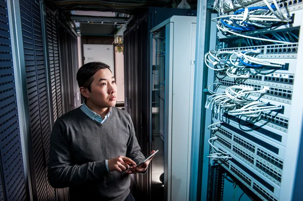 Young engineer businessman in server room