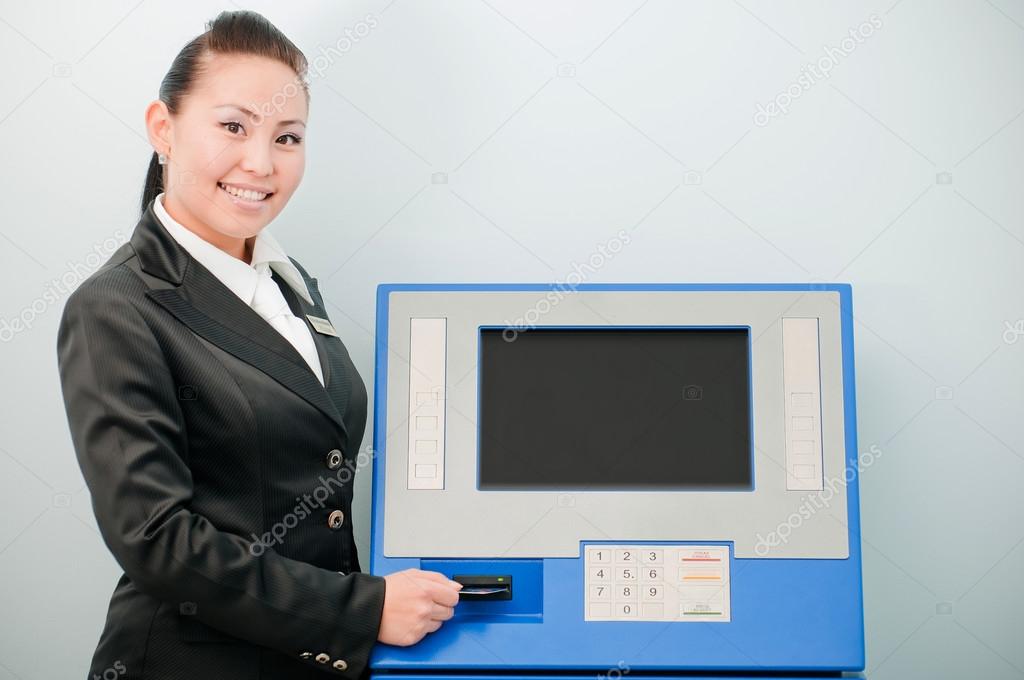 Bank worker by an ATM