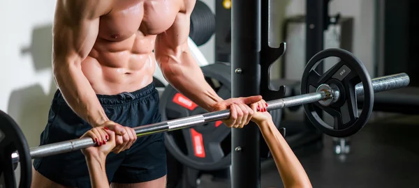 Treinador pessoal com músculos de flexão de barra no ginásio — Fotografia de Stock