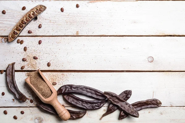 Top view carobs and flour — Stock Photo, Image