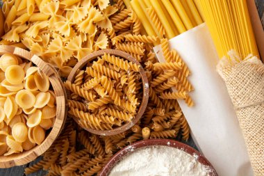 Çeşitli türlerde ve şekillerde çiğ İtalyan makarnası ve spagetti - geleneksel İtalyan yemeği arka planı