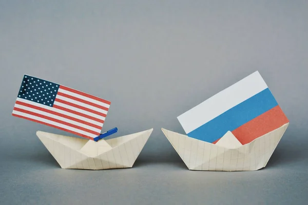 paper ship with Flags of USA and Russia. conflict,  shipment or free trade agreement and membership concept