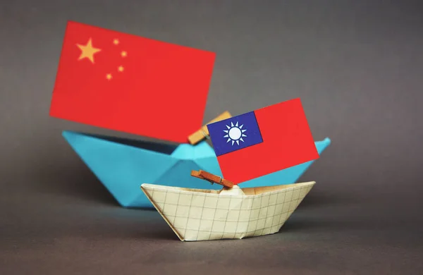 paper ship with national flag of China and Taiwan, concept of border conflict, independence and freedom shipment or free trade agreement