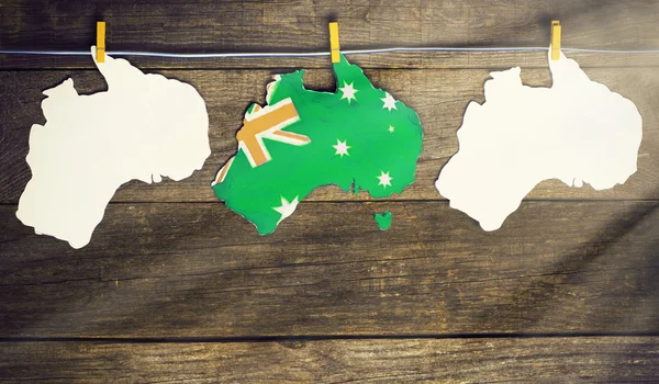 Celebrate  holiday on January 26. Concept - Happy Australia Day Map of Australia with  flag in unofficial popular green and gold colours hanging pegs on a line. toned image, sunlight effect — Stockfoto