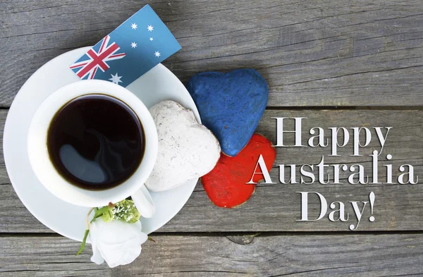 Heart shaped cookies red, white, blue.  cup of coffee (tea), Australia flag - decoration on old wooden table. notebook Happy Australia Day and koala. Sunny morning. Toned colored — Stock Fotó