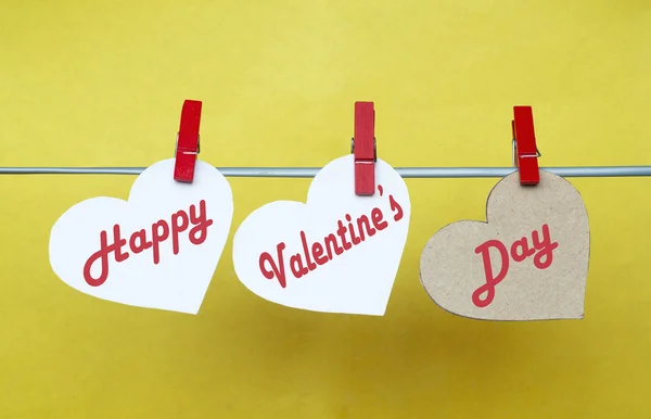 White and Red hearts with clothespins hanging on clothesline on — Stok fotoğraf