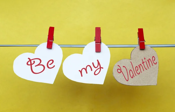 White and Red hearts with clothespins hanging on clothesline on — 图库照片