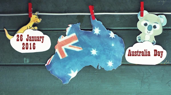 Australian with Tasmania maps and flag hanging pegs ( clothespin ) kangaroos and koala on a line against a wood background. January 26 2016 with a Happy Australia Day Space for text, toned image — ストック写真