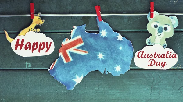 Australian with Tasmania maps and flag hanging pegs ( clothespin ) kangaroos and koala on a line against a wood background. January 26 2016 with a Happy Australia Day Space for text, toned image — 图库照片