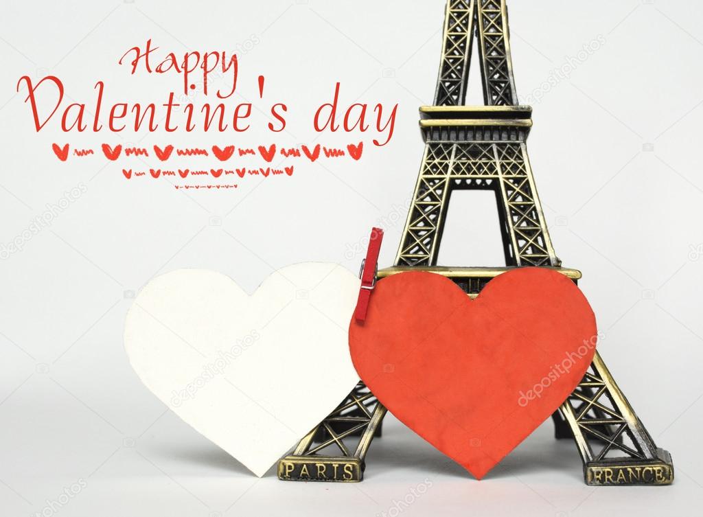 Eiffel tower and hand with paper hearts on white. Paris cards as