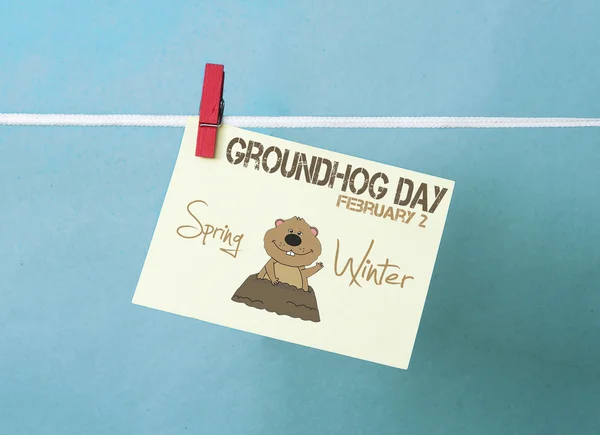 Happy Groundhog Day - white paper stiker on colorous peg (clo — стоковое фото